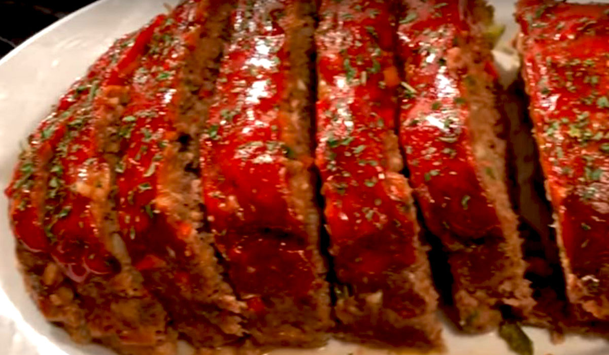 A perfectly sliced old-fashioned meatloaf with a caramelized ketchup glaze on top.