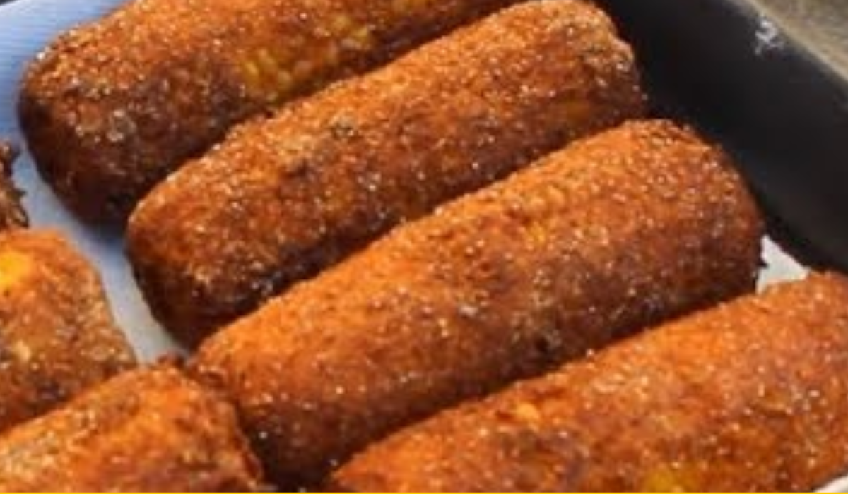 Air fried corn on the cob with a crispy cornmeal coating on a white plate.