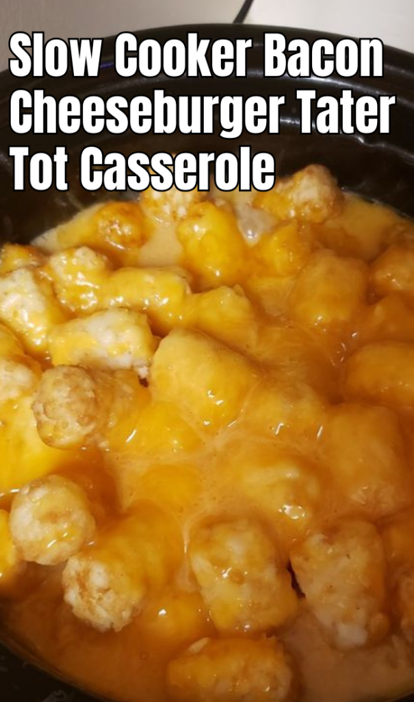 A slow cooker filled with bacon cheeseburger tater tot casserole, golden and bubbling with melted cheese on top.
