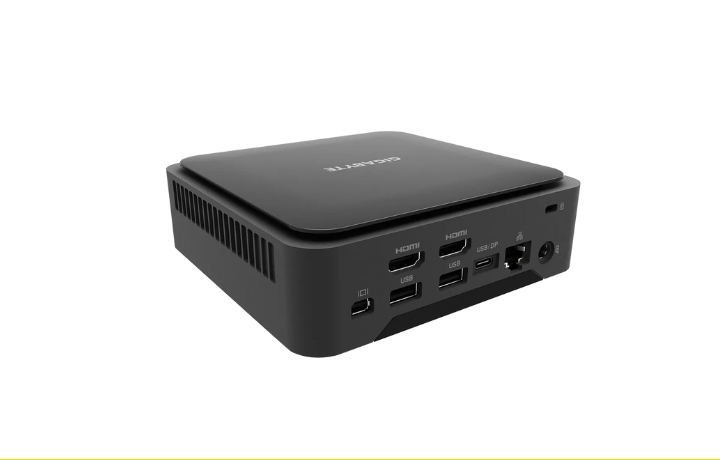 Gigabyte BRIX Mini PC with Ryzen 7 8840U placed beside a monitor and accessories on a modern desk